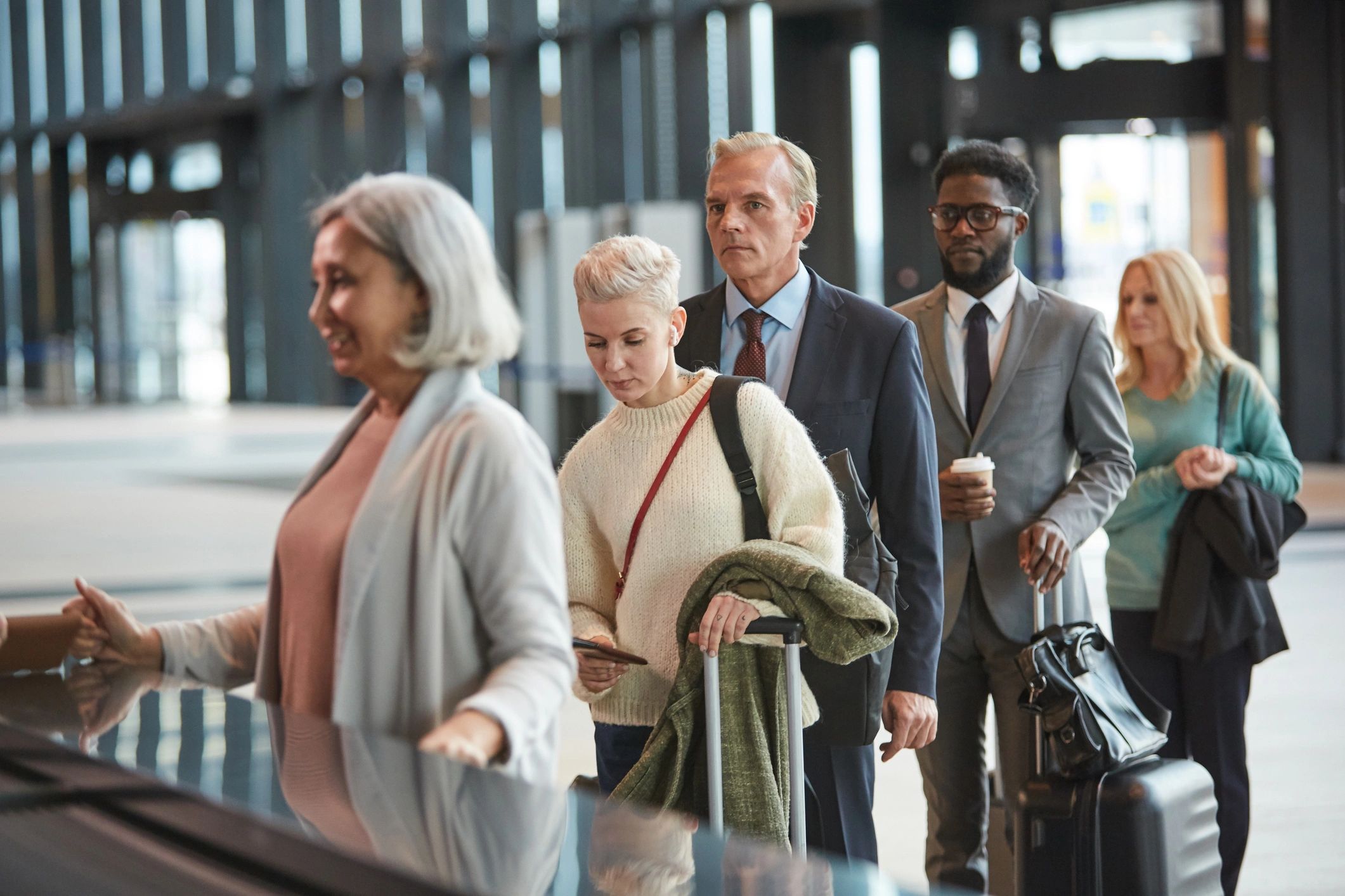 Travelers at an airport check-in counter