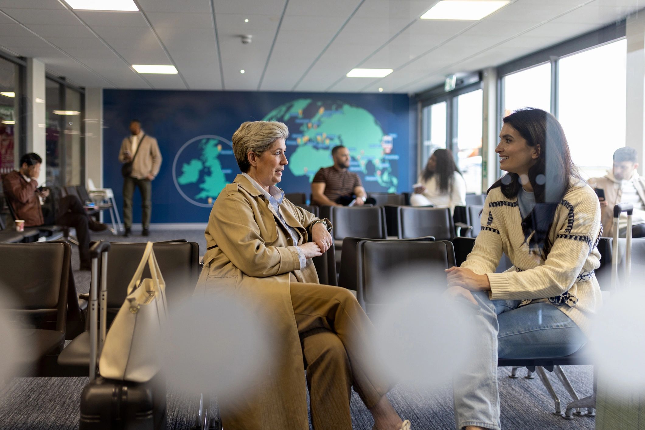 Corporate travelers meeting in an airport lounge