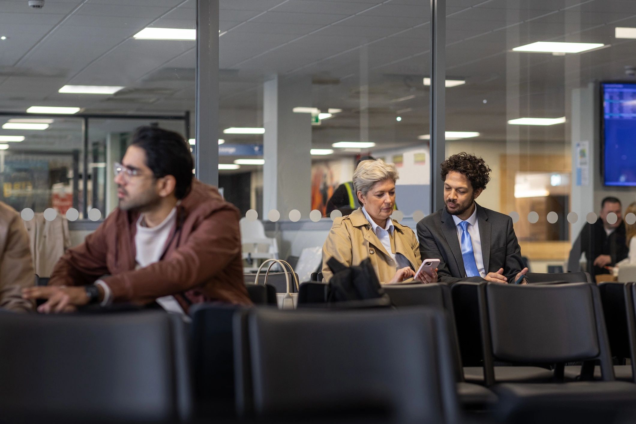 Business travellers in an airport departure lounge