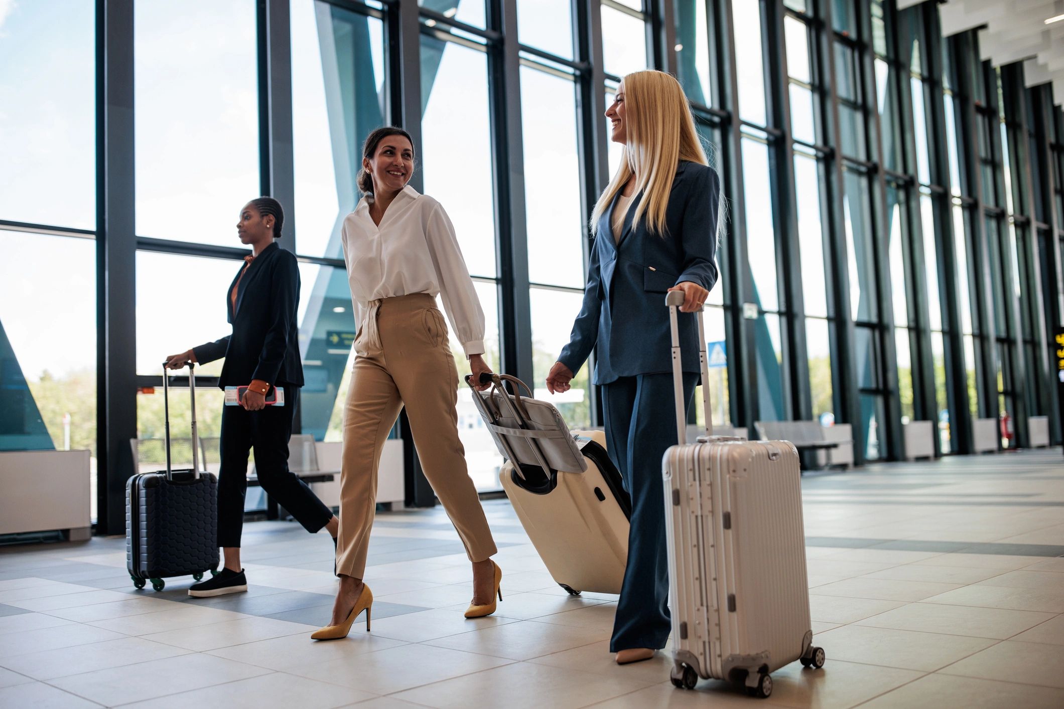 Business travelers walking through an airport terminal