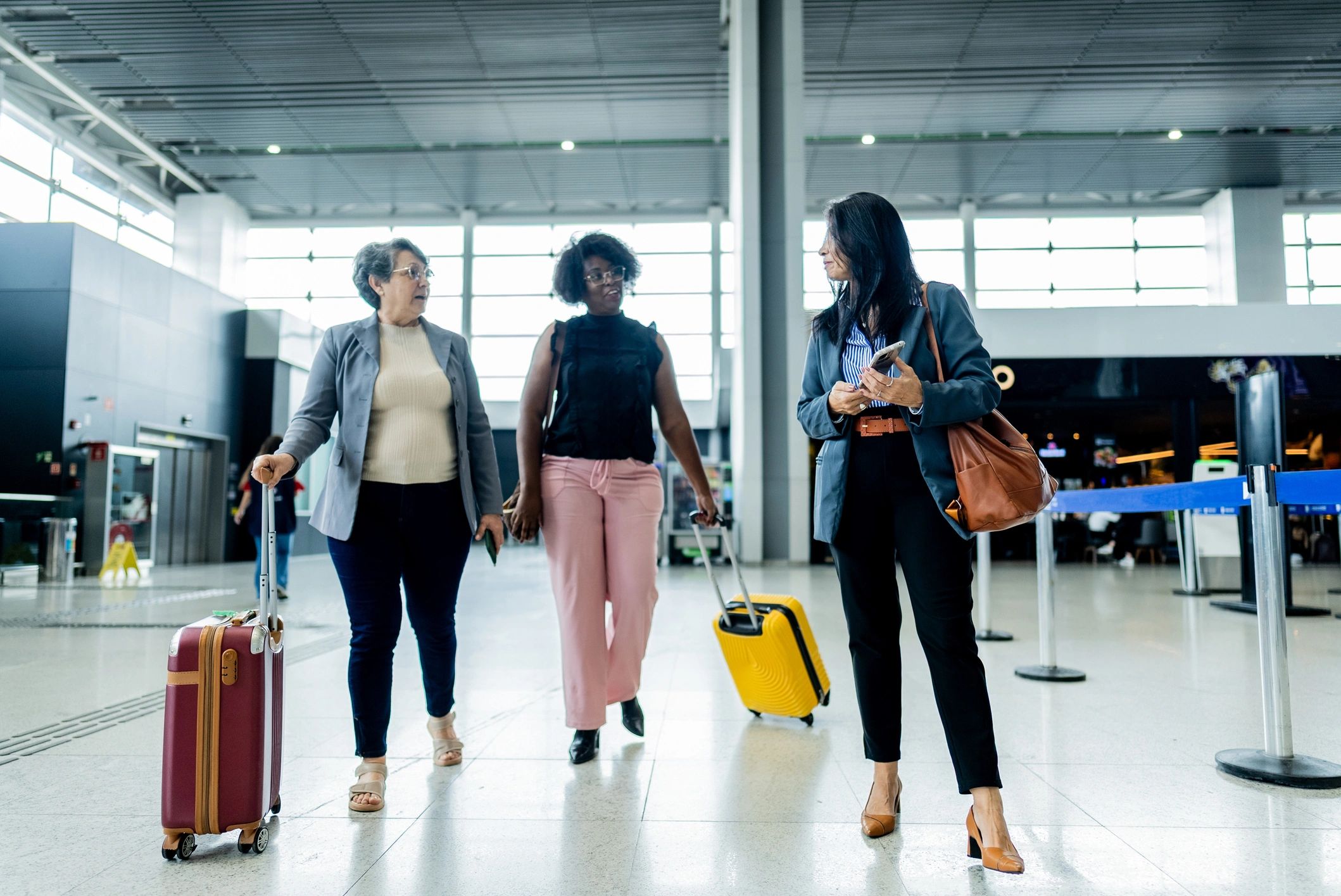 Businesswomen walking and talking at an airport